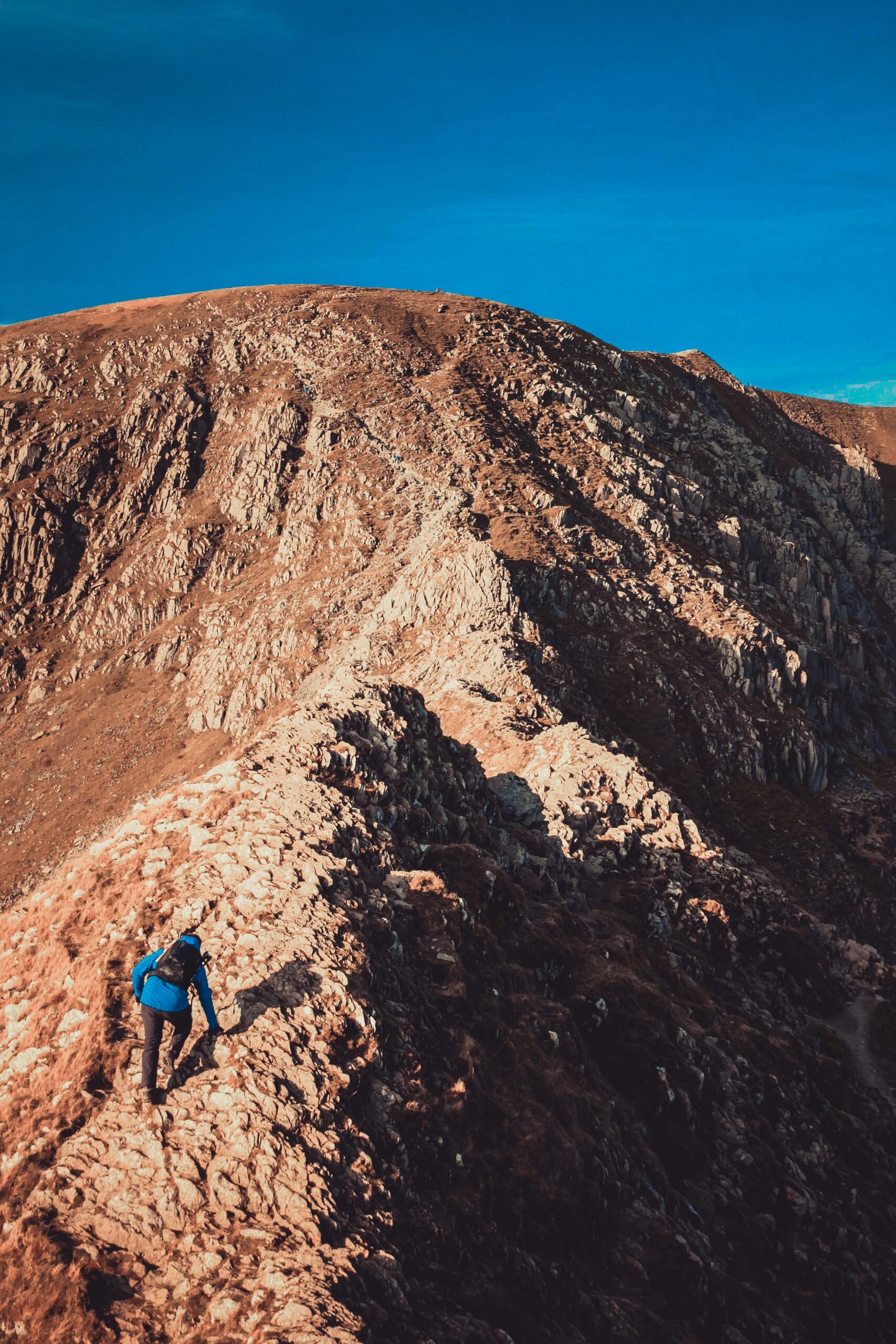 Mountain walker on Striding edge with adventuring guide jack Oliver climbing Helvellyn